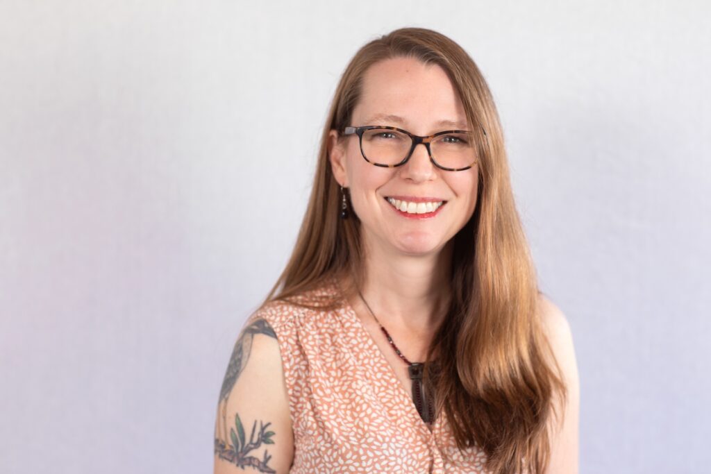 Smiling woman with bird tattoo