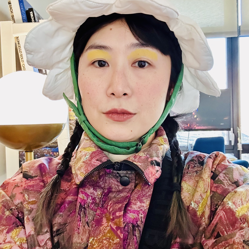 A photo of Stine An wearing a flower hat.