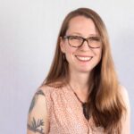 Smiling woman with bird tattoo